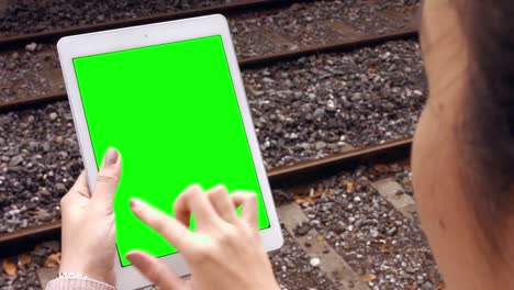 Businesswoman-using-tablet-on-train-platform