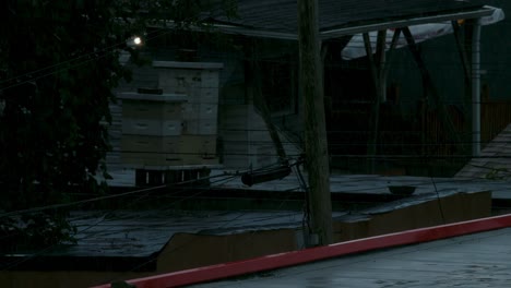 establishing shot. rain falling on apartment building roof in slow motion.