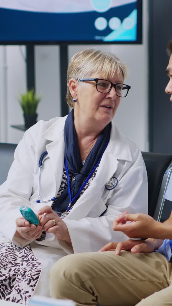 Vertical video: Doctor taking patient insulin level test