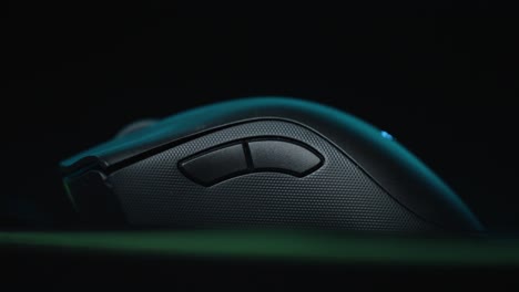 close up of gaming mouse with rgb lights against a black background