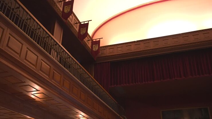 Ornate wooden beams and ceiling in old interior hallway with banners.
