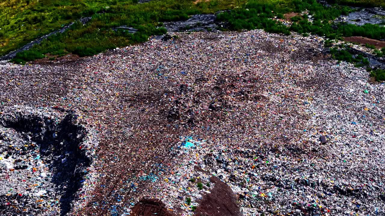 Mixed recycled plastic landfill pollution contaminated land dump garbage, aerial drone