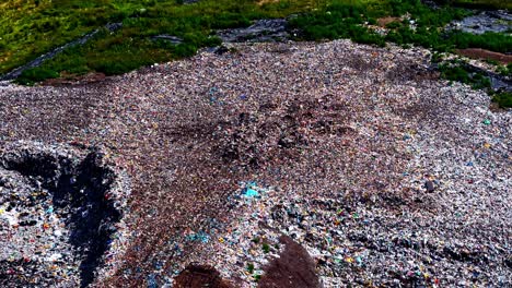 mixed recycled plastic landfill pollution contaminated land dump garbage, aerial drone