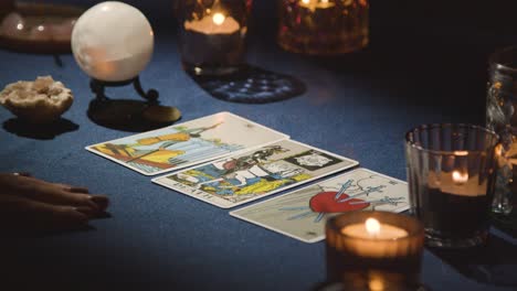 Close-Up-Of-Woman-Giving-Tarot-Card-Reading-On-Candlelit-Table-4