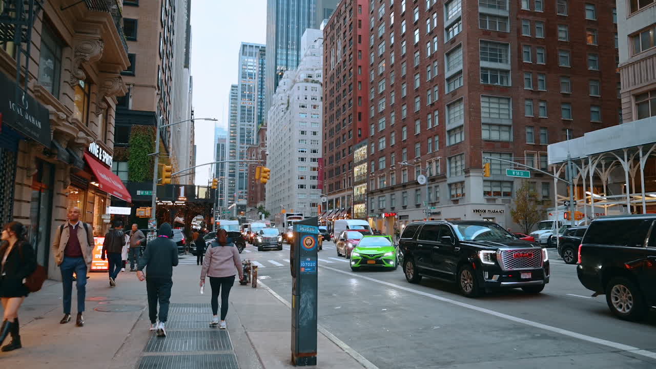 New York, USA, 8 October 2025: New York Street Evening Scene. Evening traffic and pedestrians fill a busy Manhattan street with tall buildings