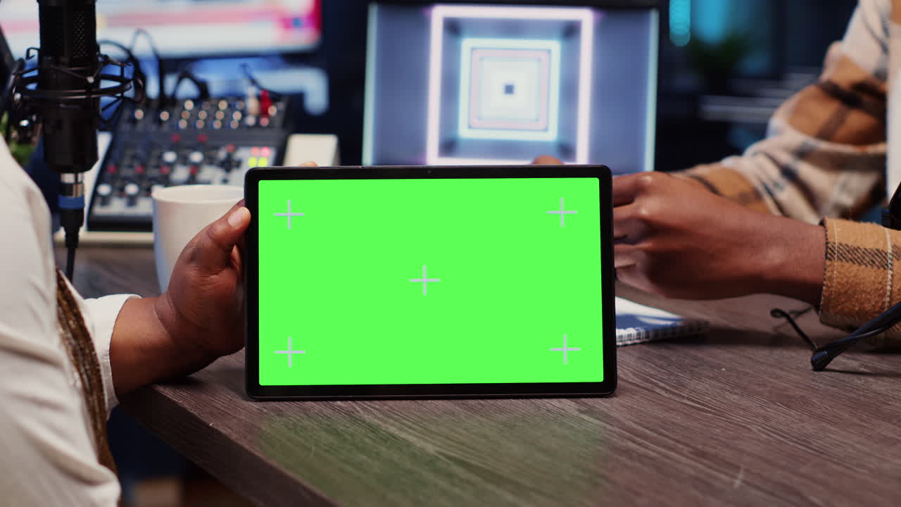 Man watches clips on mockup tablet, invited to podcast with host in apartment studio