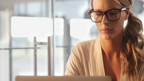 Woman-in-spectacles-sitting-in-cafe