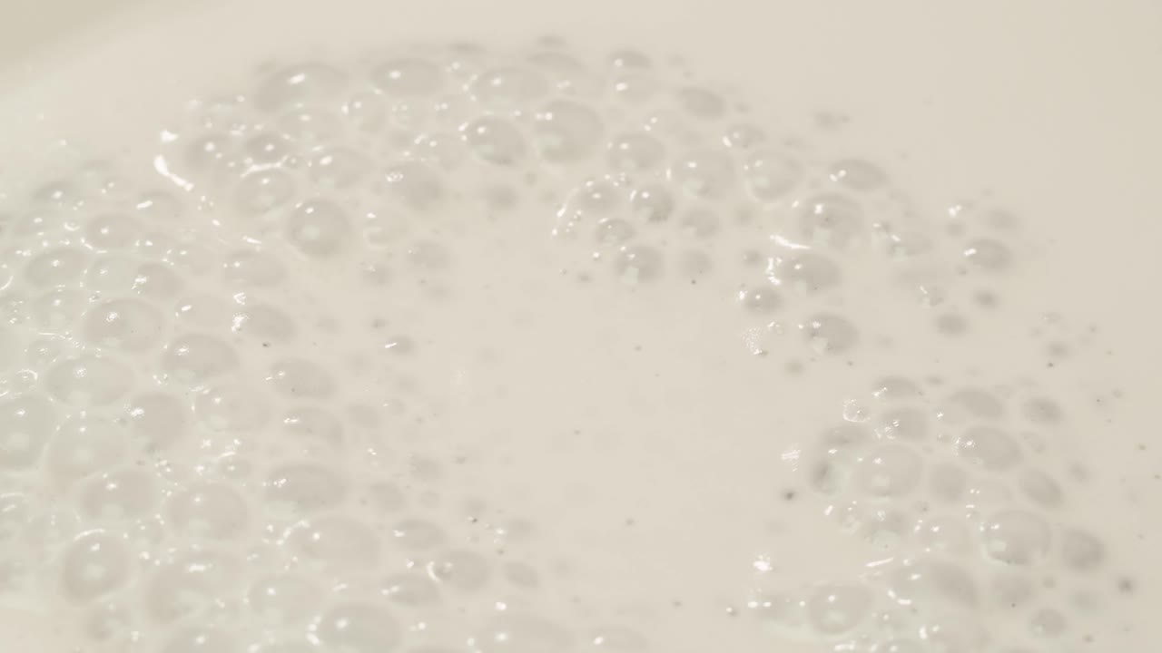 Close-up of white liquid with bubbles