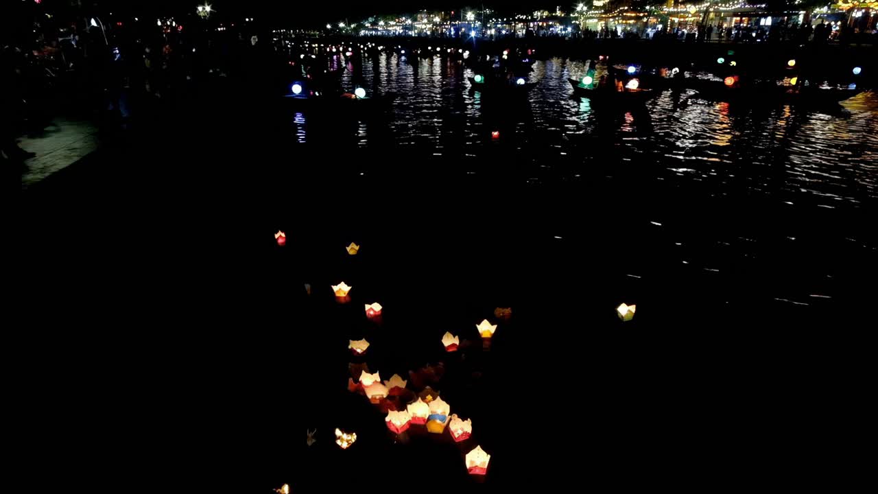 Tiny floating lanterns on the serene Thu Bon river signify "peace, goodwill, and harmony."