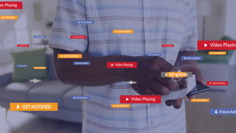 animation of social media icons with texts over african american man cleaning smartphone