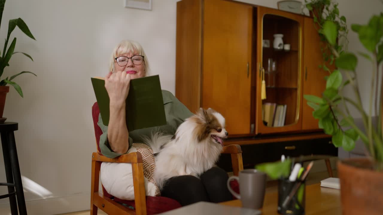 Senior Woman Reading with Dog