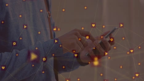 animation of network of digital icons against mid section of man using smartphone at office