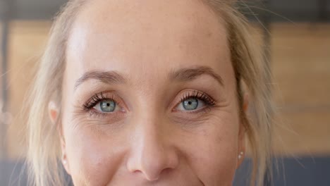 Portrait-close-up-of-happy-unaltered-caucasian-woman-taking-a-break-at-gym,-slow-motion