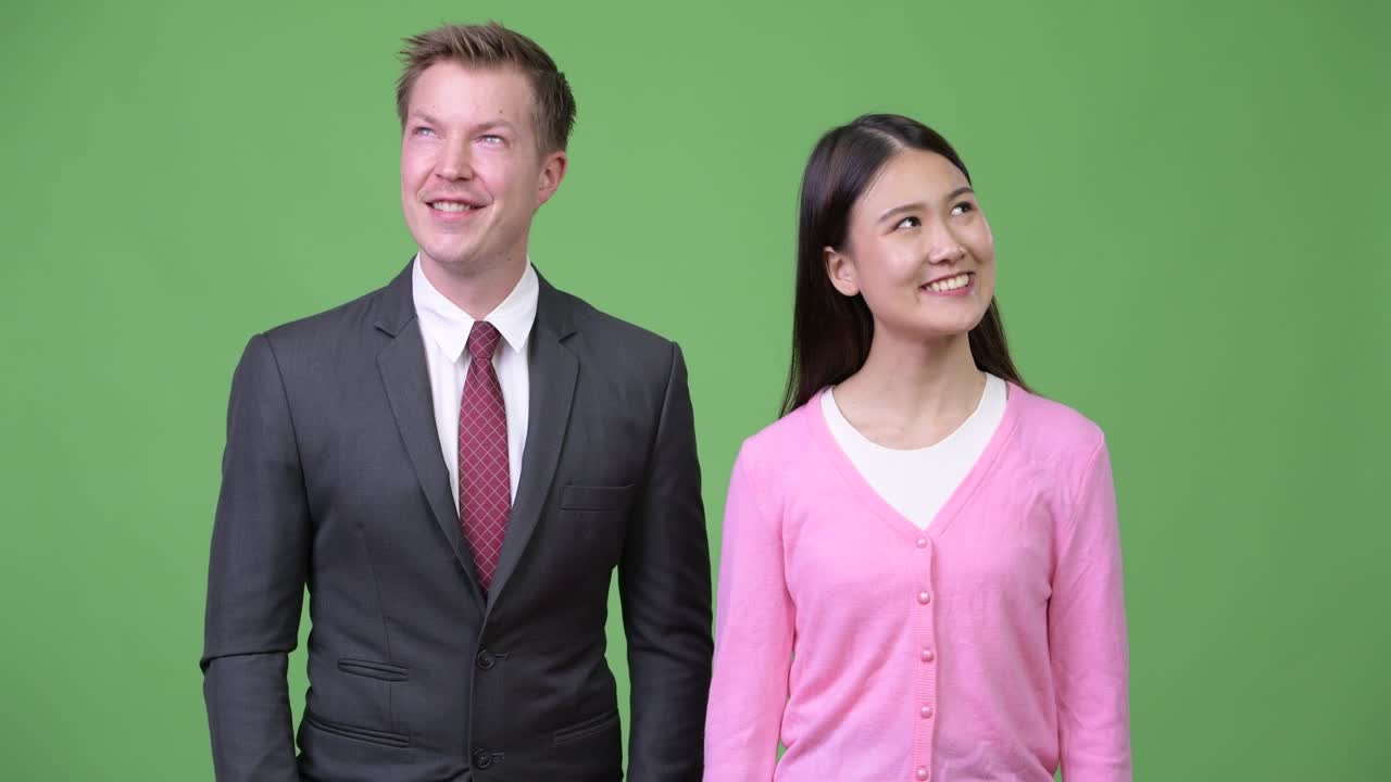 Young Asian woman and young businessman thinking together