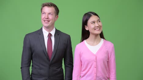 young asian woman and young businessman thinking together