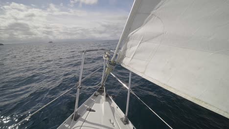 Sailboat-Sailing-In-The-Ocean-On-A-Sunny-Summer-Day---POV-From-Deck-Of-Boat---wide-shot