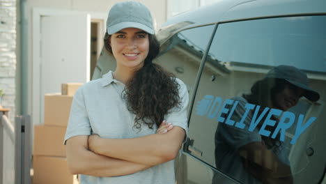 smiling delivery person by van