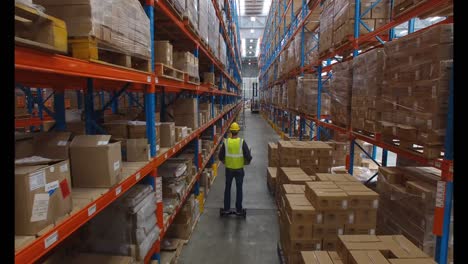 Warehouse-worker-carrying-cardboard-box-on-hoverboard-