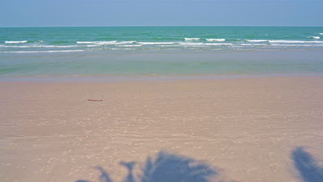 island beach area at sunny cloudless weather, low tides coming to the white sandy beach daytime