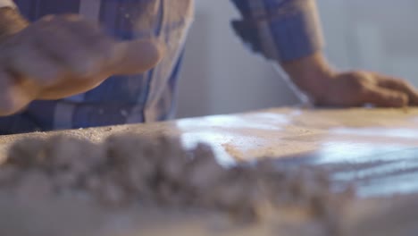 The-carpenter-is-cleaning-the-chips-and-dust-from-the-wood.