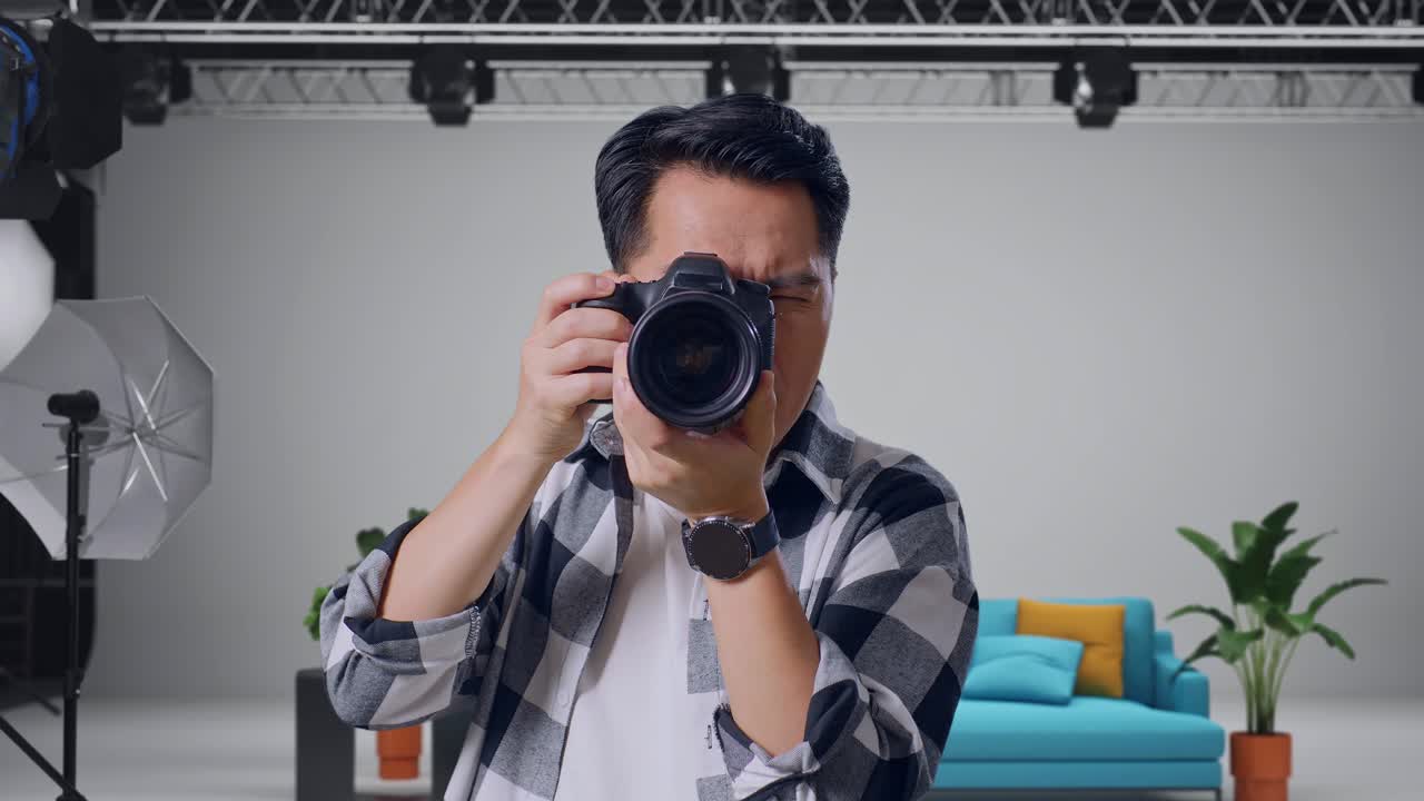Close Up Of Asian Photographer Having A Neck Ache After Using A Camera Taking Some Pictures While Standing In The Studio
