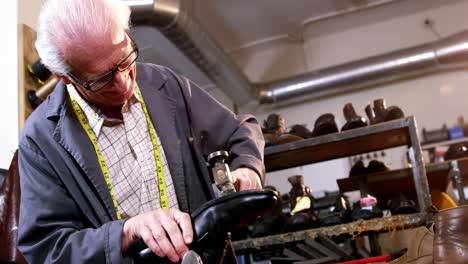 shoemaker hammering on a shoe