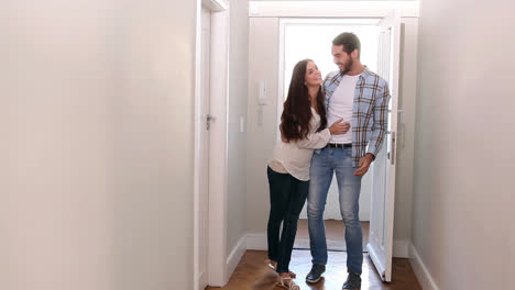 attractive couple opening the front door