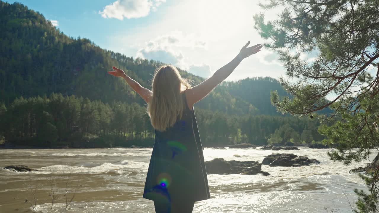 Woman enjoying the view of a mountain river