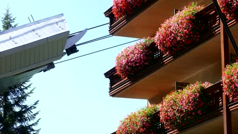 cable car in motion next to a building.