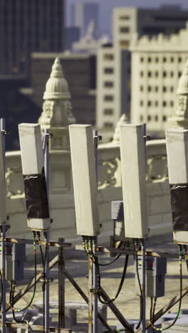 rooftop utility equipment with city buildings in the background during daylight