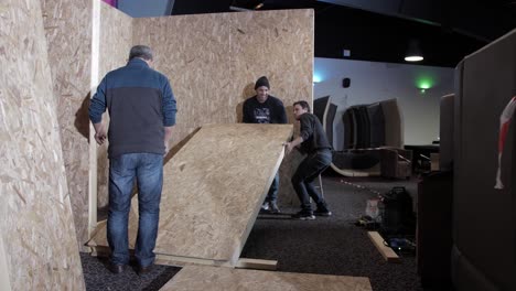 construction workers installing plywood panels