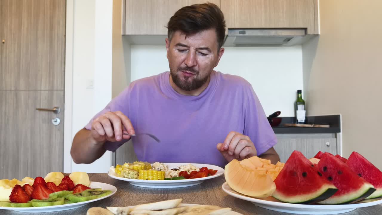 Man eating a healthy meal of fruits and vegetables