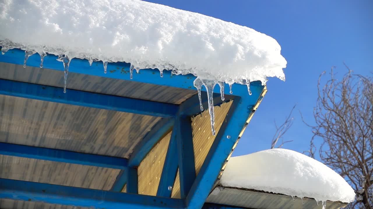 The water dripping from icicles. Shooting in the winter. Slow motion