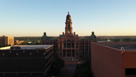 Drone-footage-of-downtown-Fort-Worth,-Texas-Courthouse,-skyscrapers-and-buildings-at-sunset