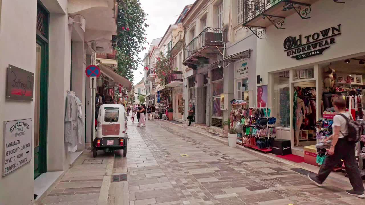 Walking down a narrow street in a Greek old town