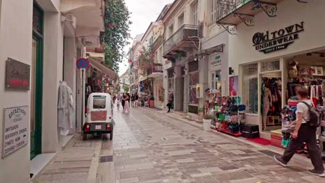 walking down a narrow street in a greek old town