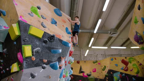 teenage boy bouldering indoors