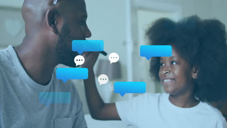 Chat bubbles animation over smiling man and child interacting indoors