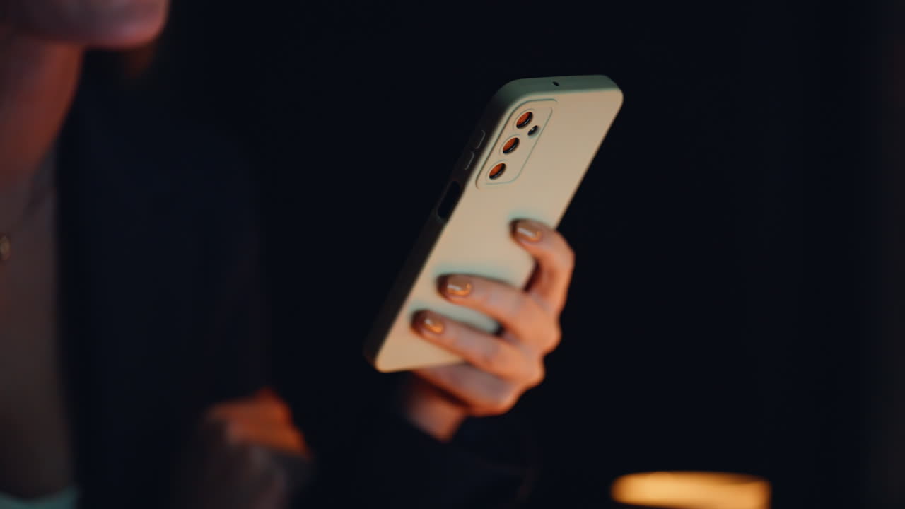 Hand using cell night office closeup. Unknown businesswoman tapping mobile phone