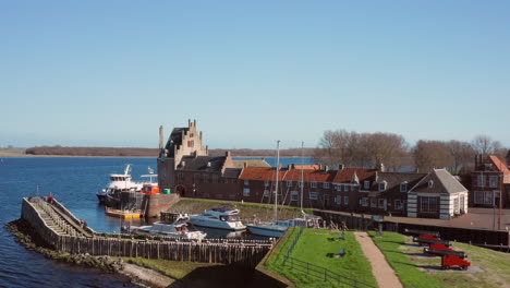 Aerial:-The-historical-town-of-Veere-with-an-old-harbour-and-churches,-on-a-spring-day