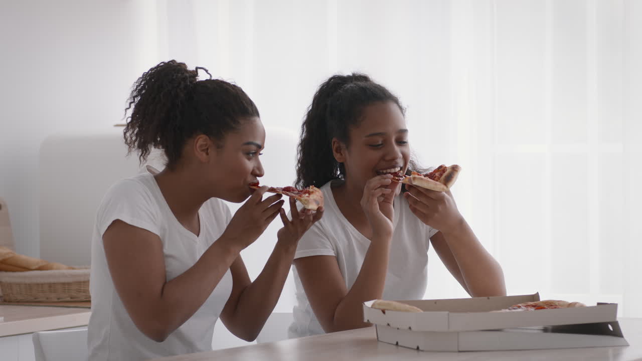 Sisters Enjoying Pizza