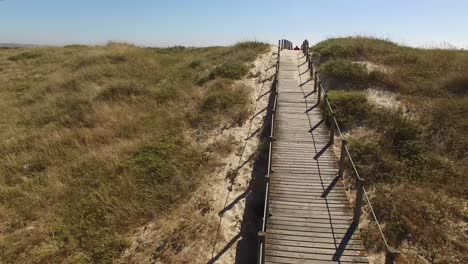 flying over walkway in direction to the beach over dunes