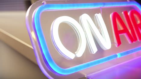 on air neon sign with studio equipment