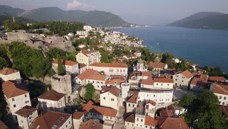 drone flying backward over nikola djurkovic square in herceg novi, coastal village in montenegro