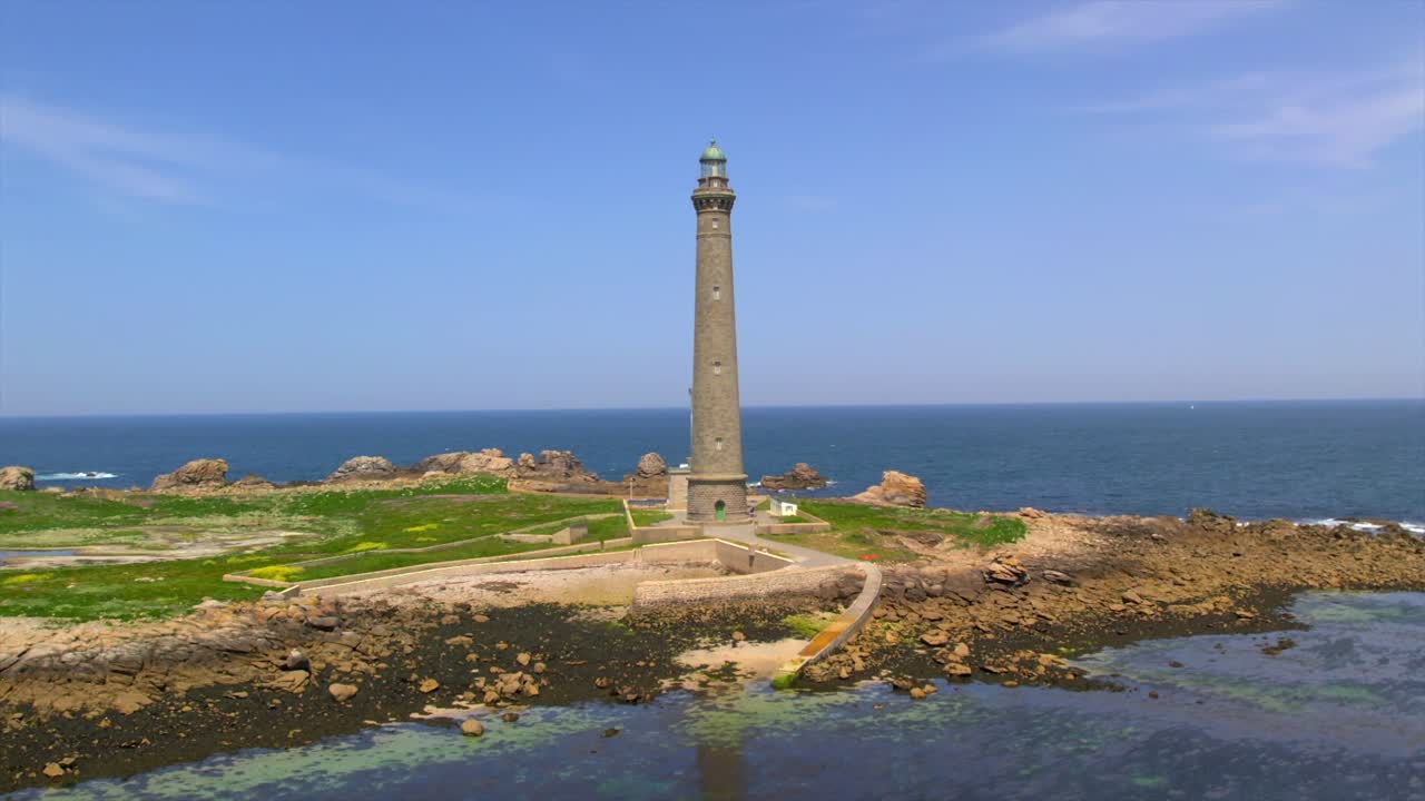 Aerial View of a Tall Lighthouse on a Rocky Island
