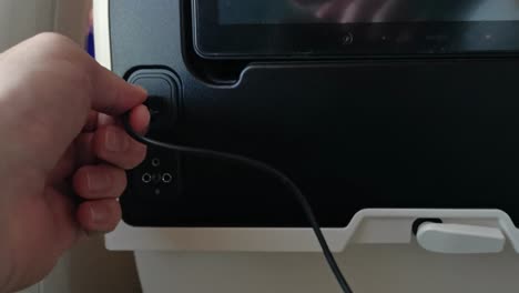 plugging a usb device into the seat of an economy class seat