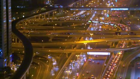 cars driving at night in sheikh zayed road in dubai, united arab emirates