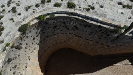 Closeup-aerial-drone-view-of-a-rounded-massive-tower-of-Berlanga-de-Duero-Cstle,-Soria,-Spain