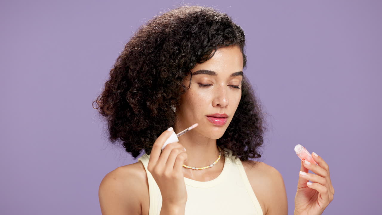 Woman applying lip gloss