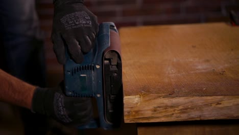 using a belt sander to sand wood